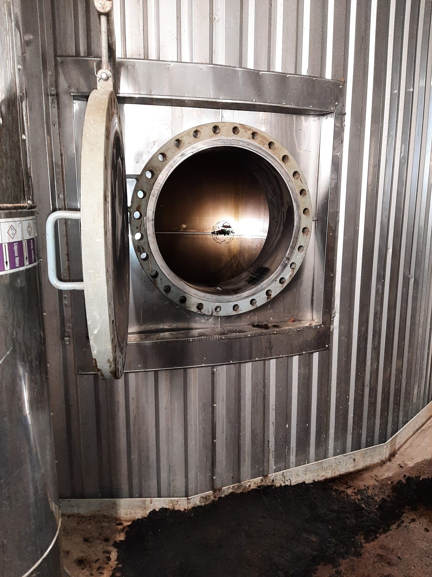 Drone entering a tank through a manhole