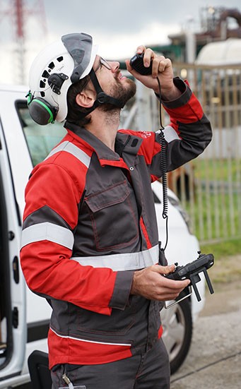 Dries Speybrouck holding a caged Elios drone at a vessel manway